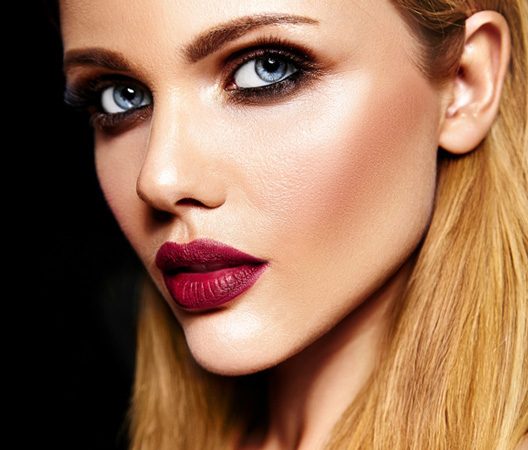 Blonde woman with blue eyes and red lipstick Moxi Treatments