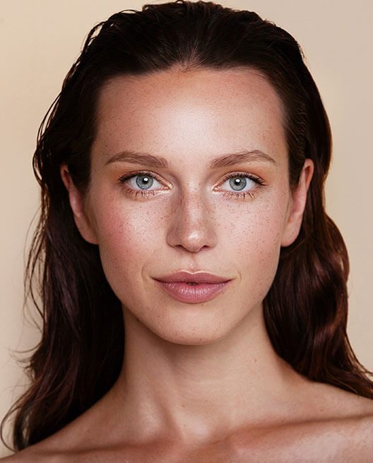 Woman with fresh glowing skin and wet hair - Aquagold Facial concept image