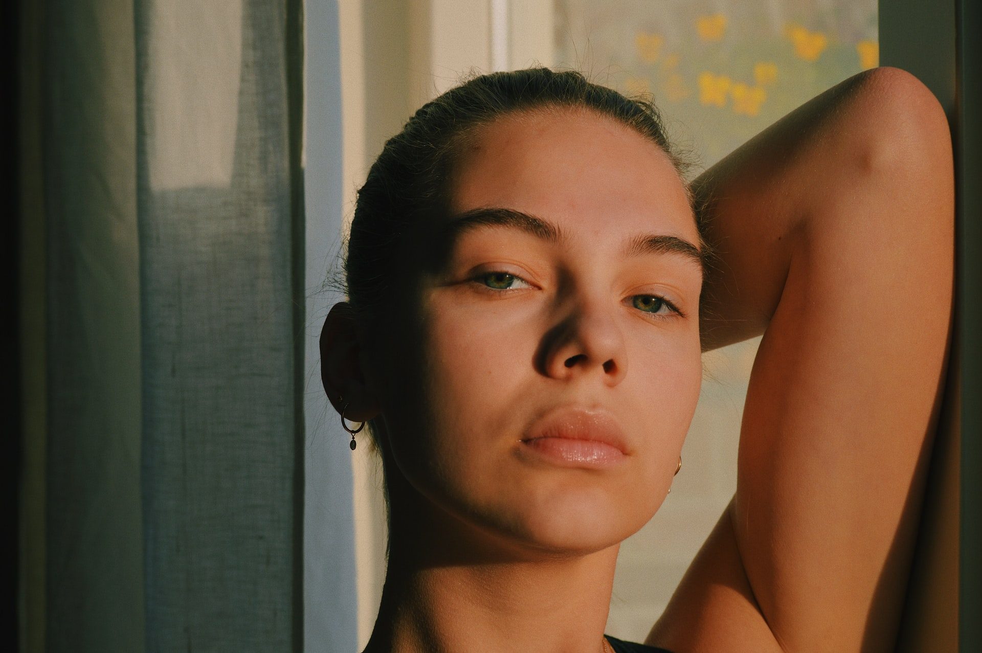 Woman posing with hand behind her head - scar removal concept image